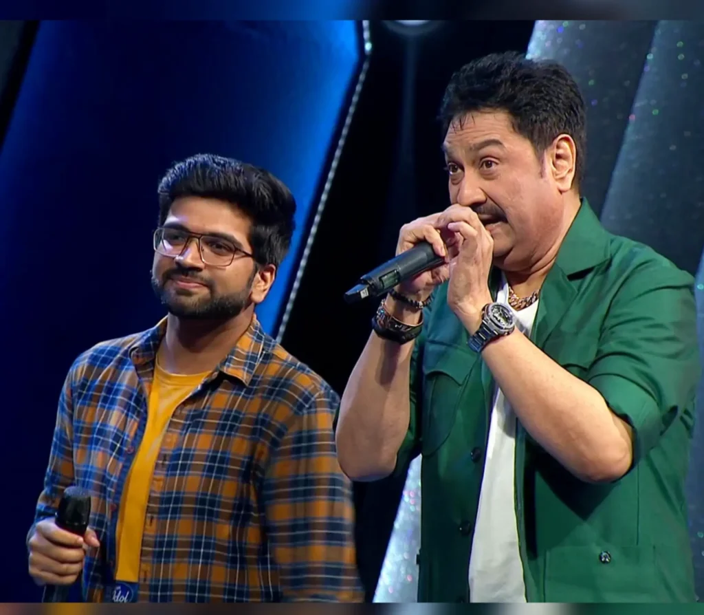 Rohan Biswal performing on stage with legendary singer Udit Narayan during a live musical show